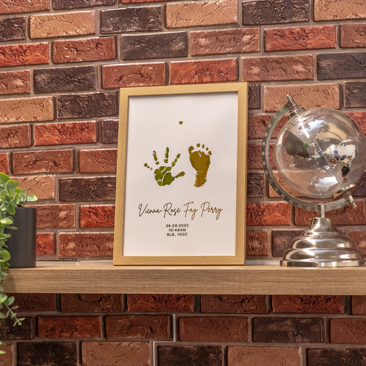 Framed artwork with hand and footprints on a brick wall background