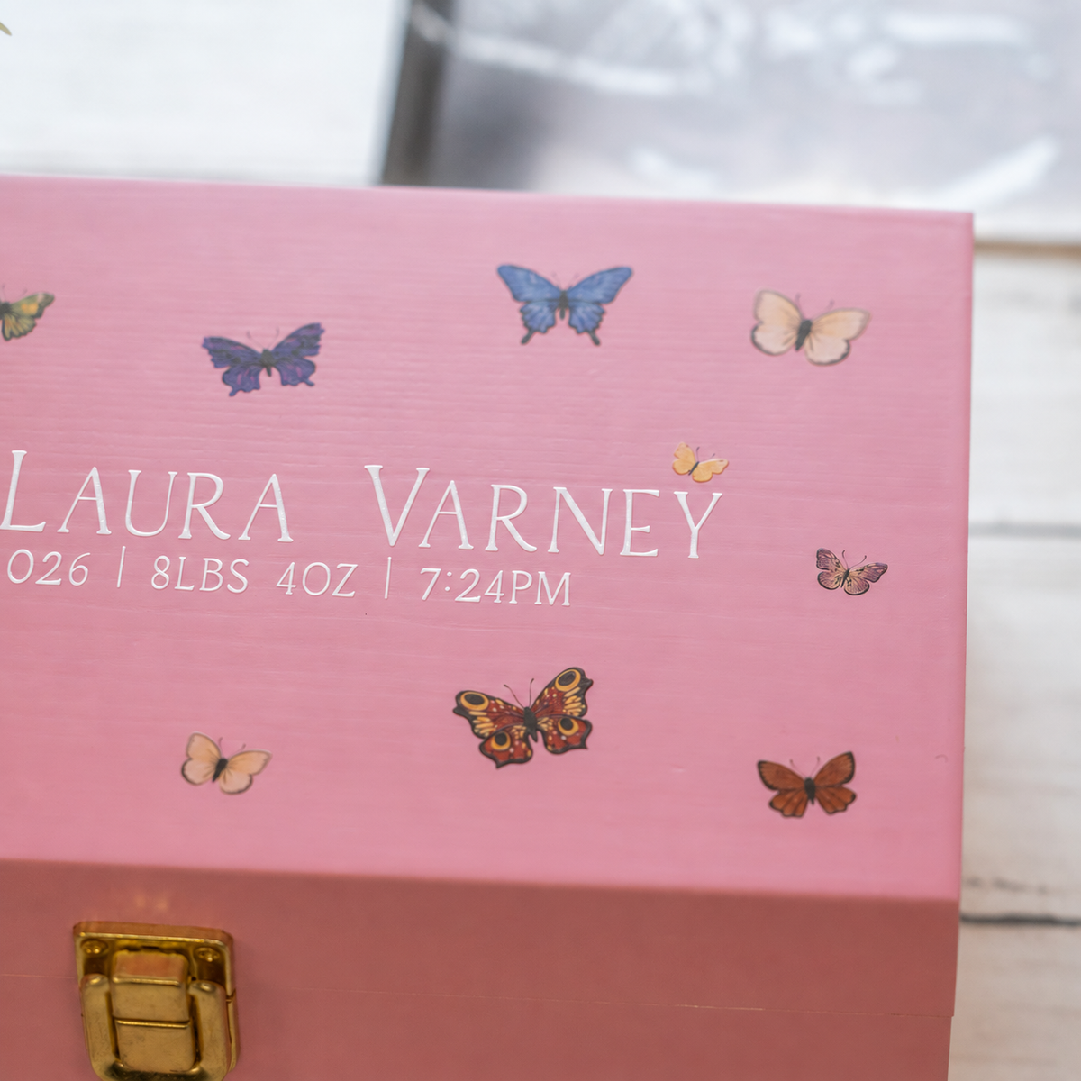 A close up shot of a pink box covered in butterflies.