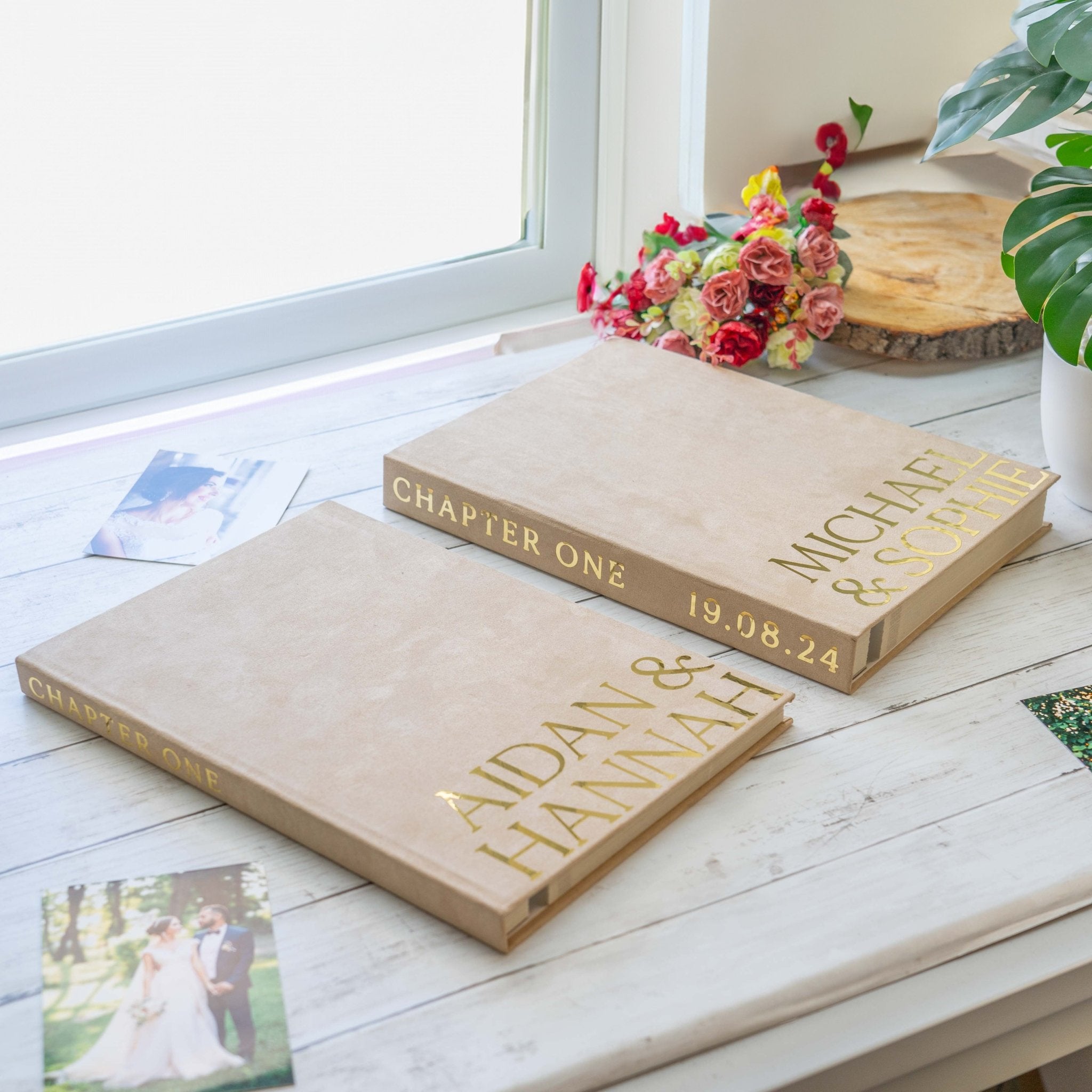 two photo albums lay down next to eachother