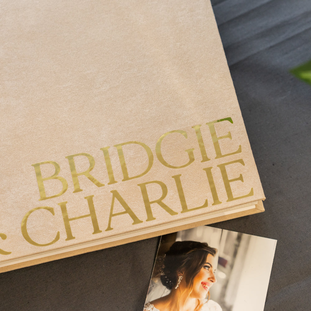 Book with 'BRIDGIE CHARLIE' on the cover and a photo of a woman inside, on a dark surface.