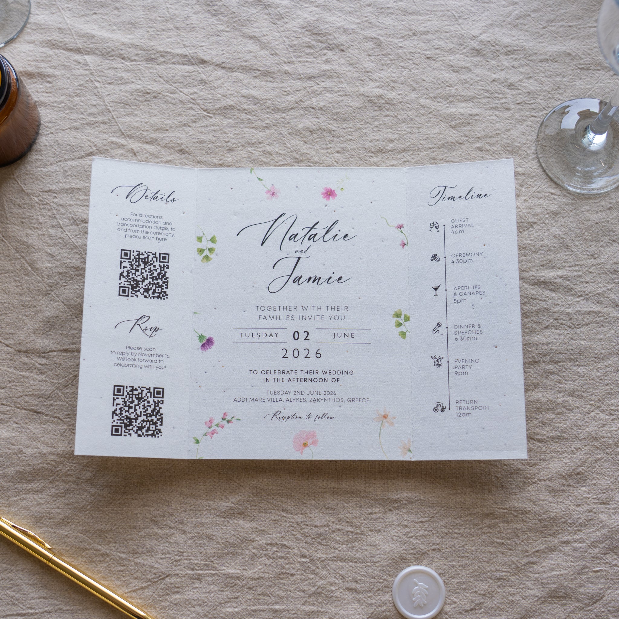 Wedding invitation card with floral designs on a textured surface