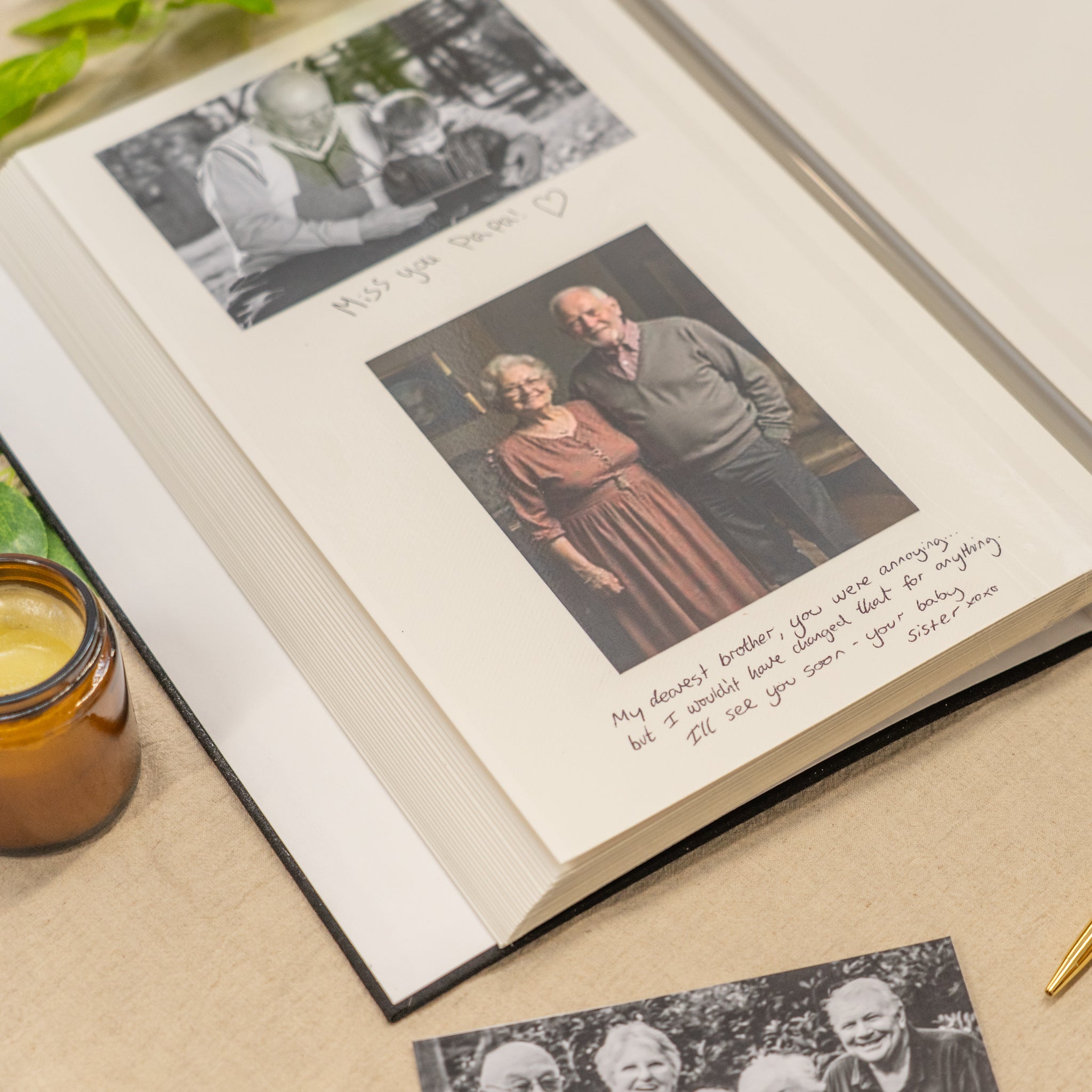 Open photo album with a couple's portrait and text on a wooden surface.