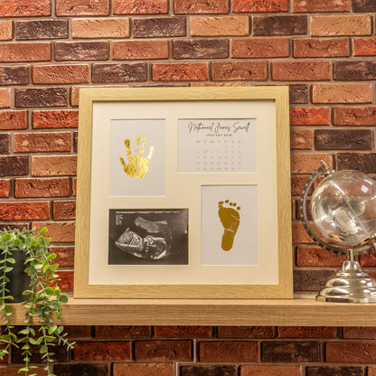 Personalised baby foil photo frame with gold handprint, footprint and ultrasound scan displayed in wooden frame