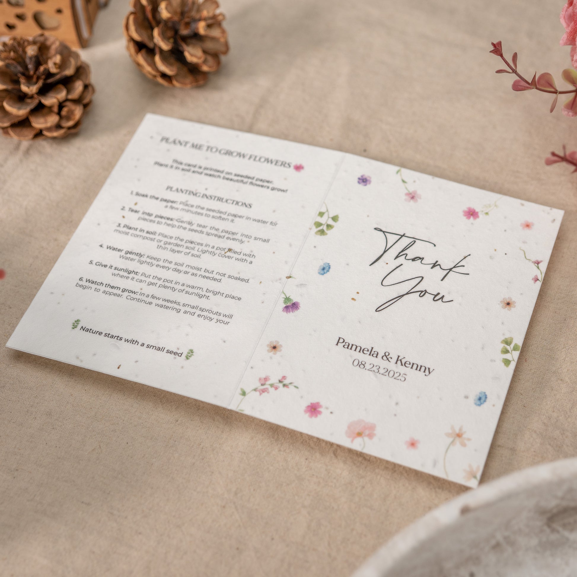Plantable seed paper card with floral design and text on a textured surface.