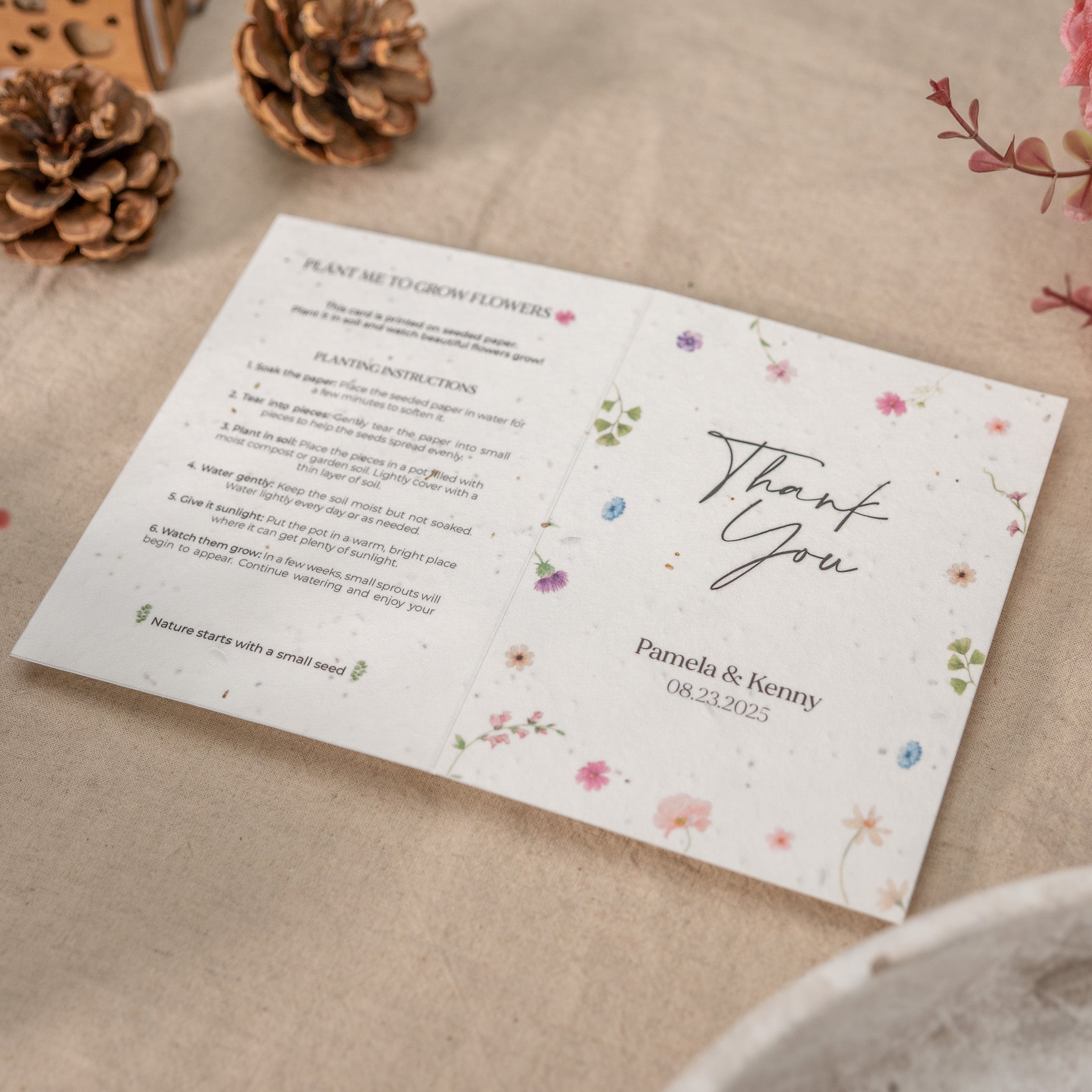 Plantable seed paper card with floral design and text on a textured surface.