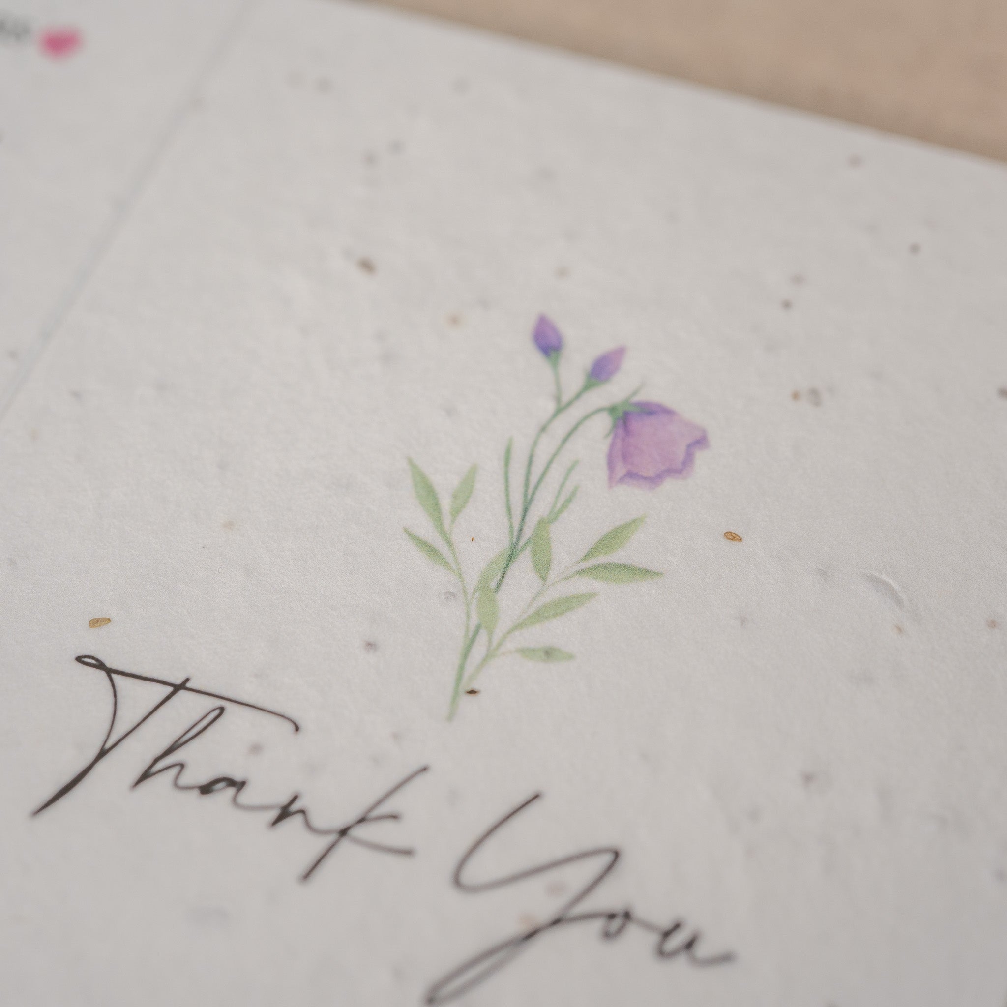 Card with floral design and 'Thank You' text on textured paper