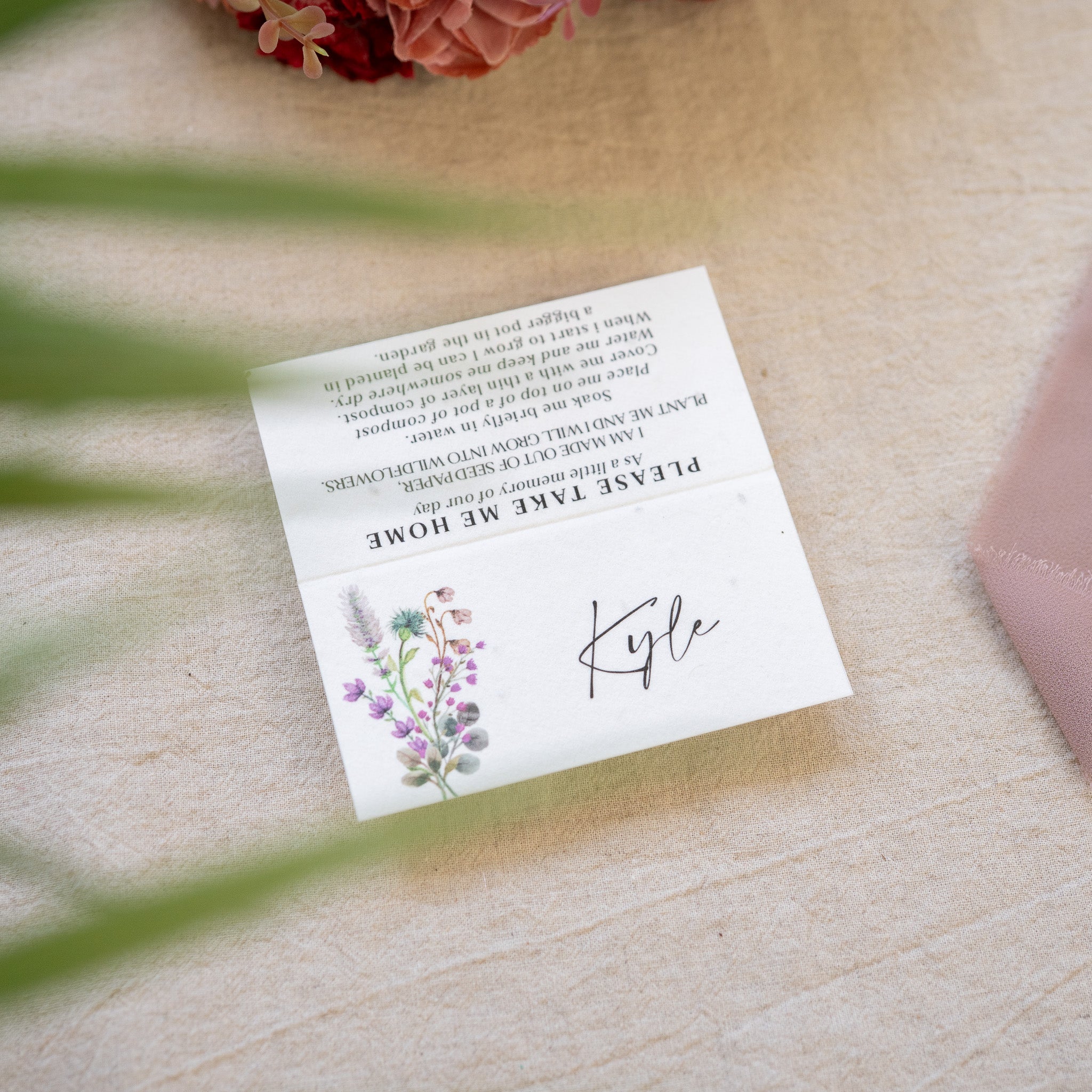 White card with floral design and text on a wooden surface