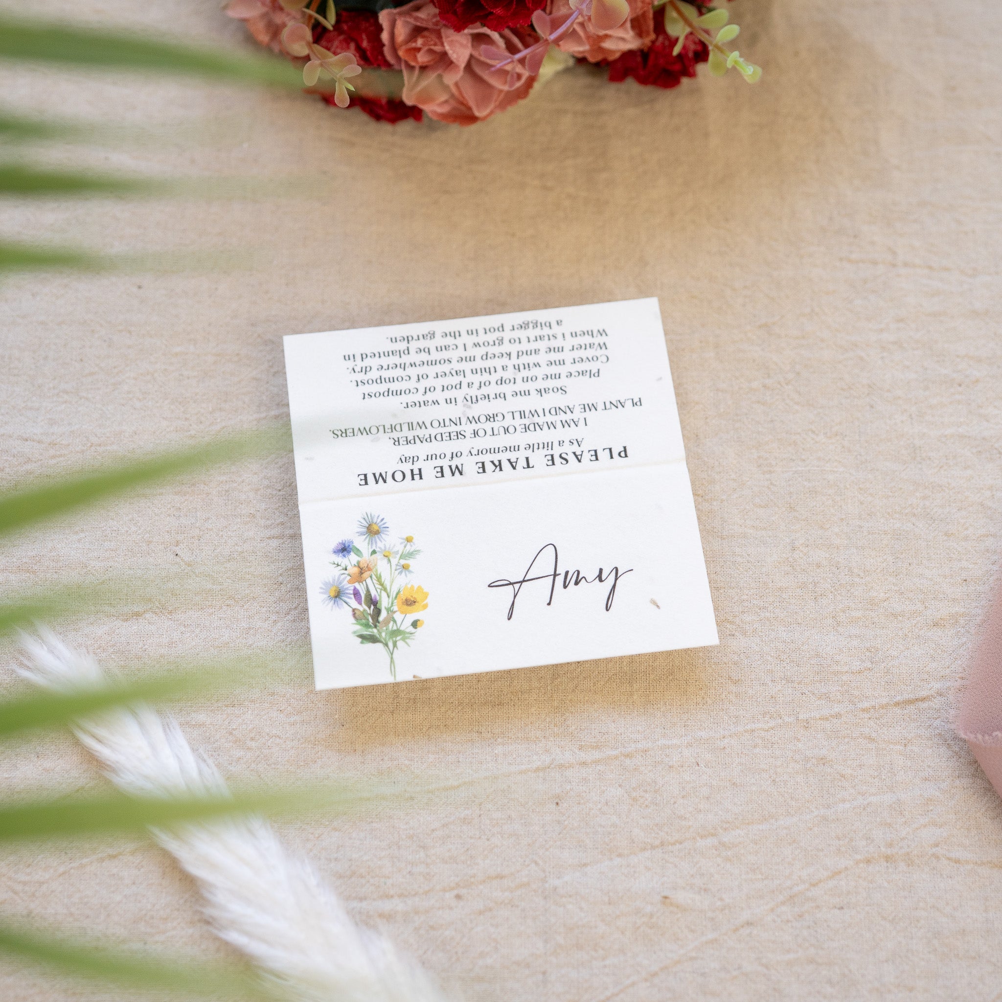 Note with floral design and text on a wooden surface