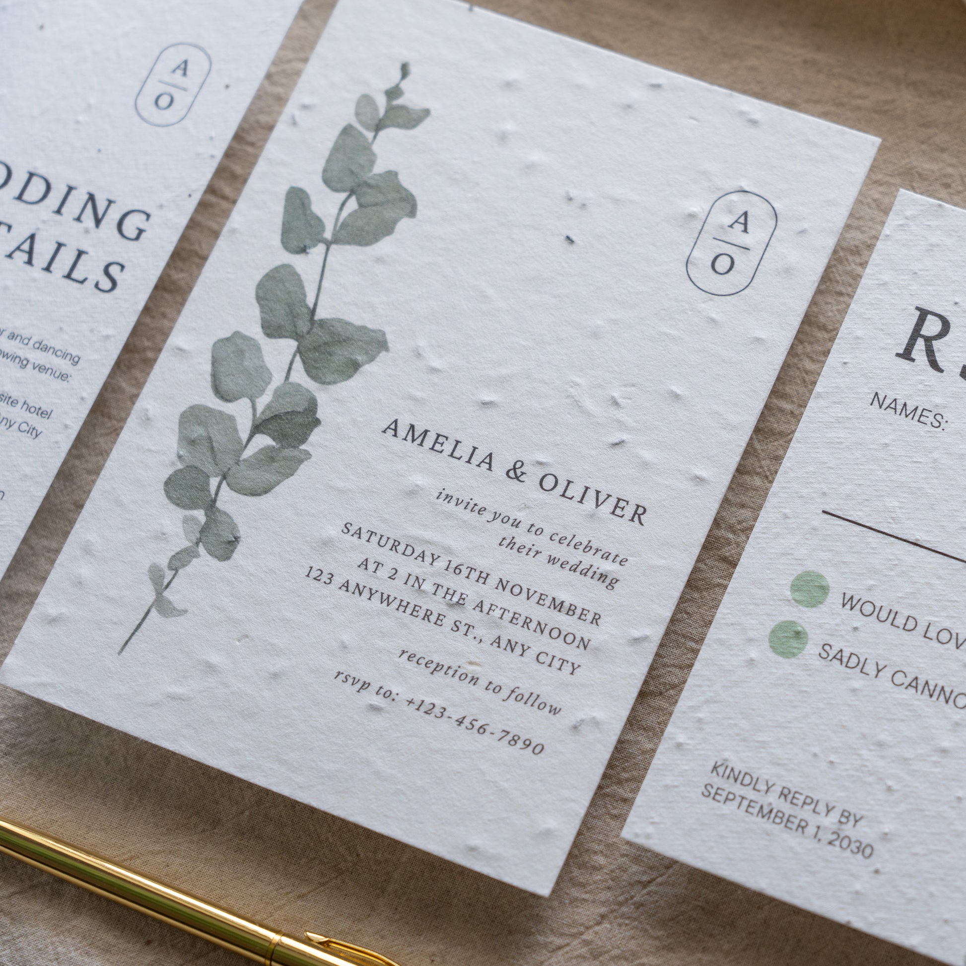 Wedding invitation card with eucalyptus design on a wooden surface