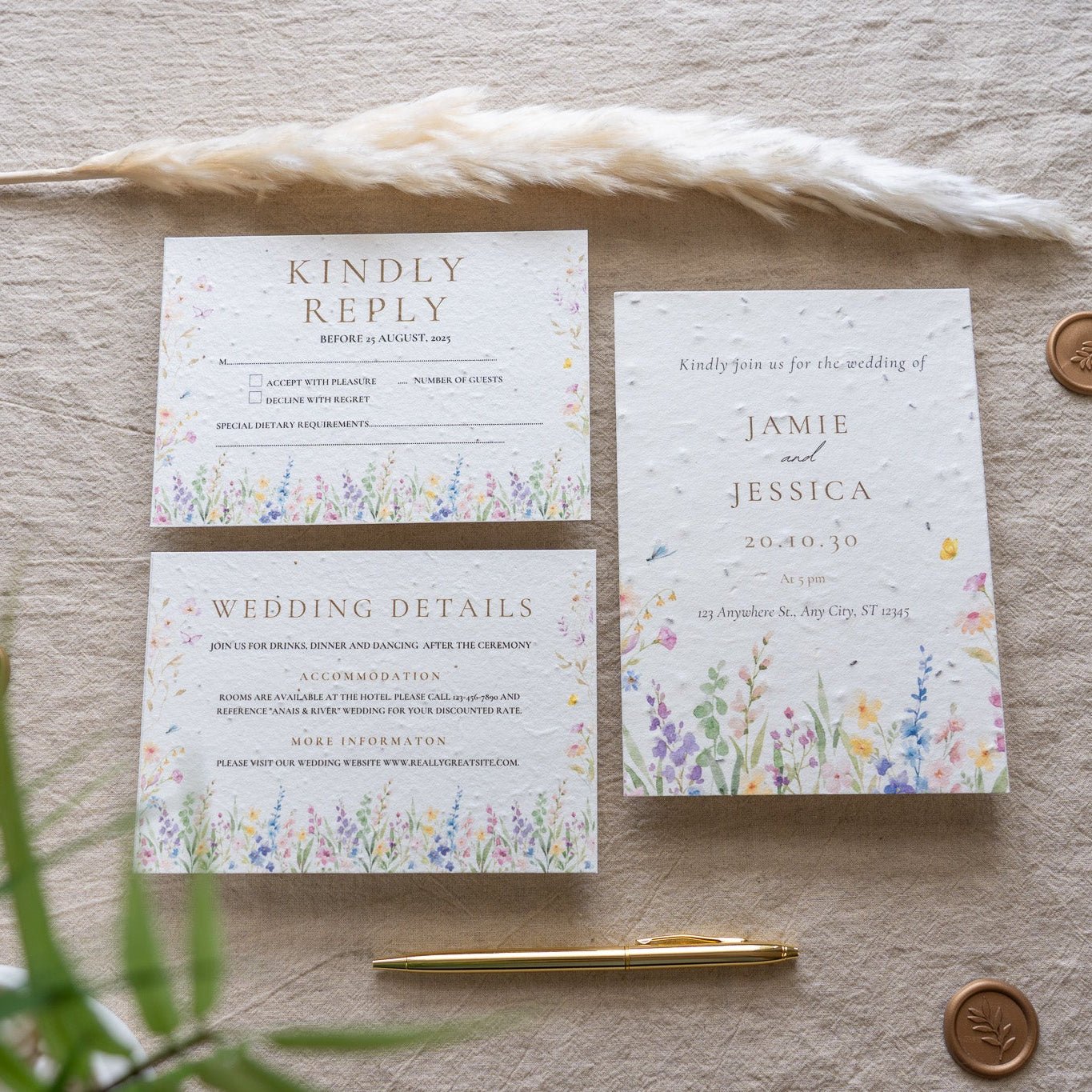 Wedding invitation set with RSVP card on a textured surface with decorative elements.