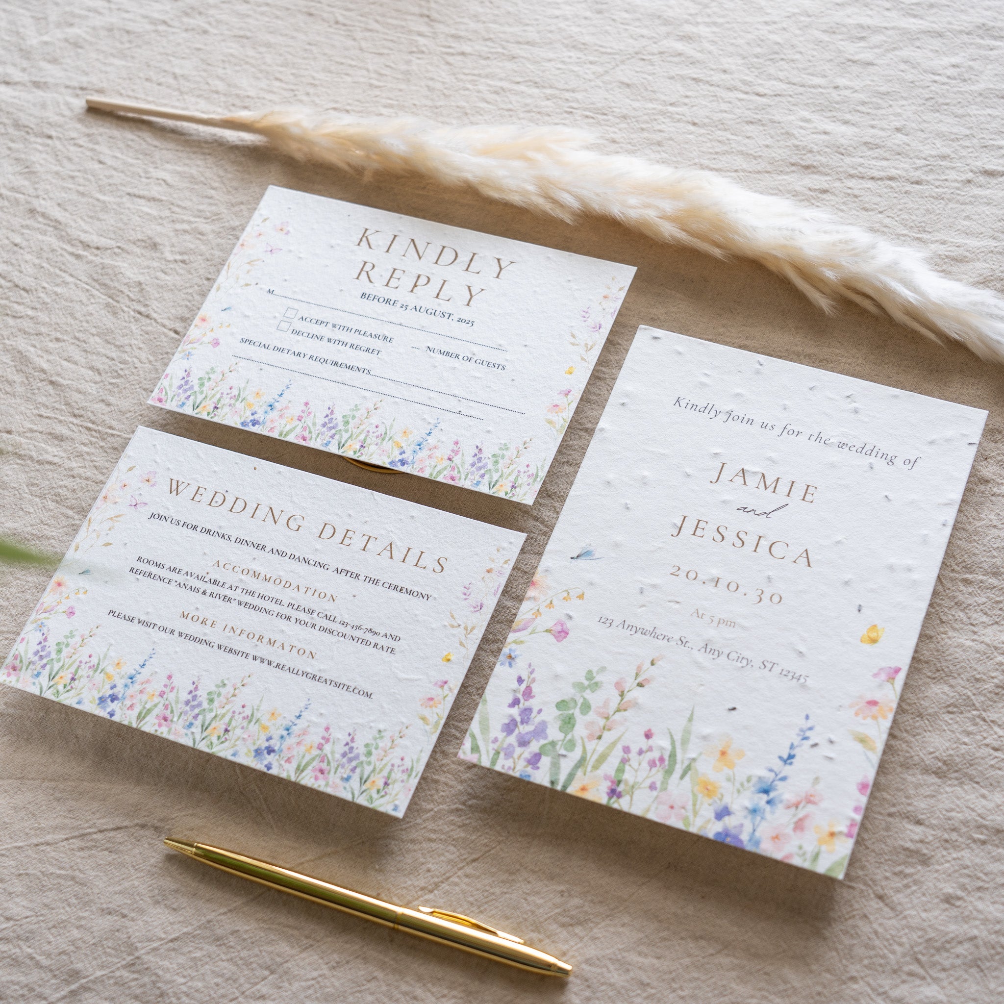Wedding invitation set with floral design on a wooden surface