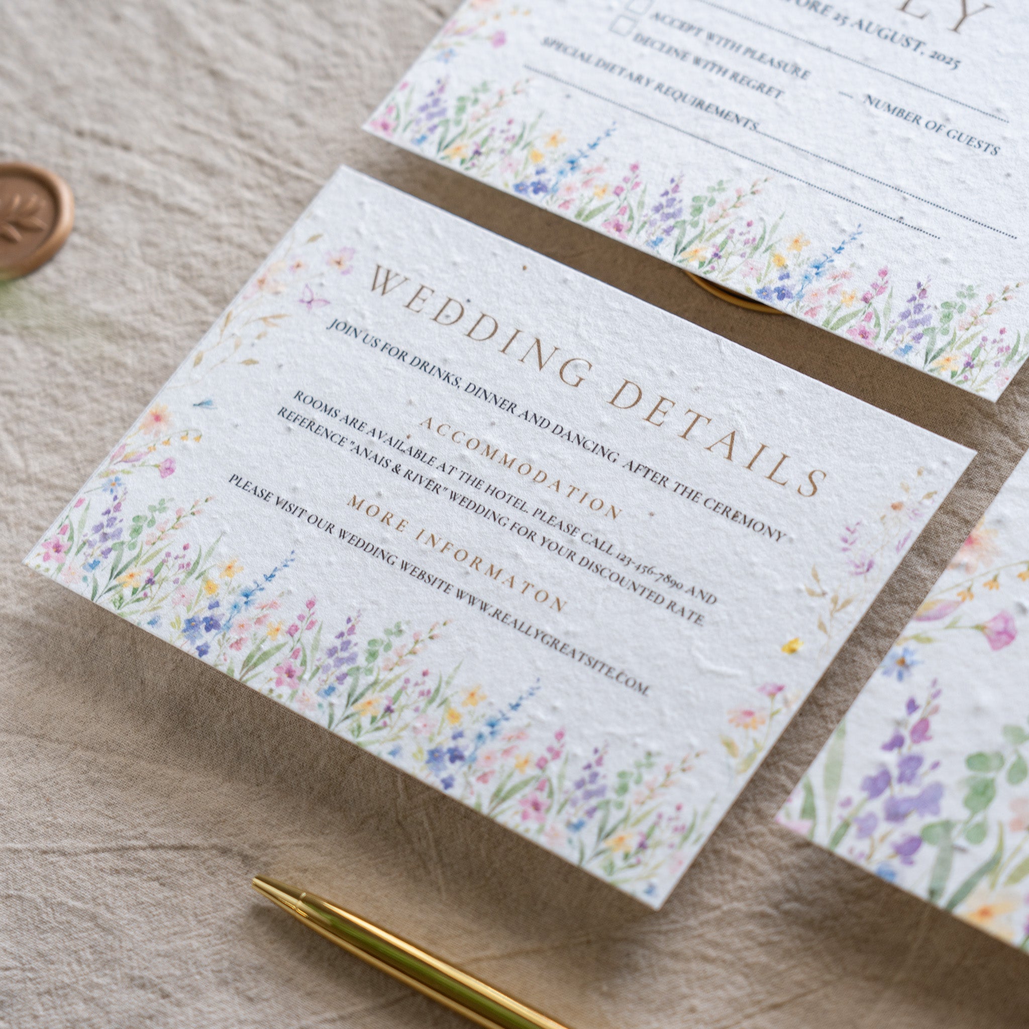 Wedding invitation card with floral design on a wooden surface