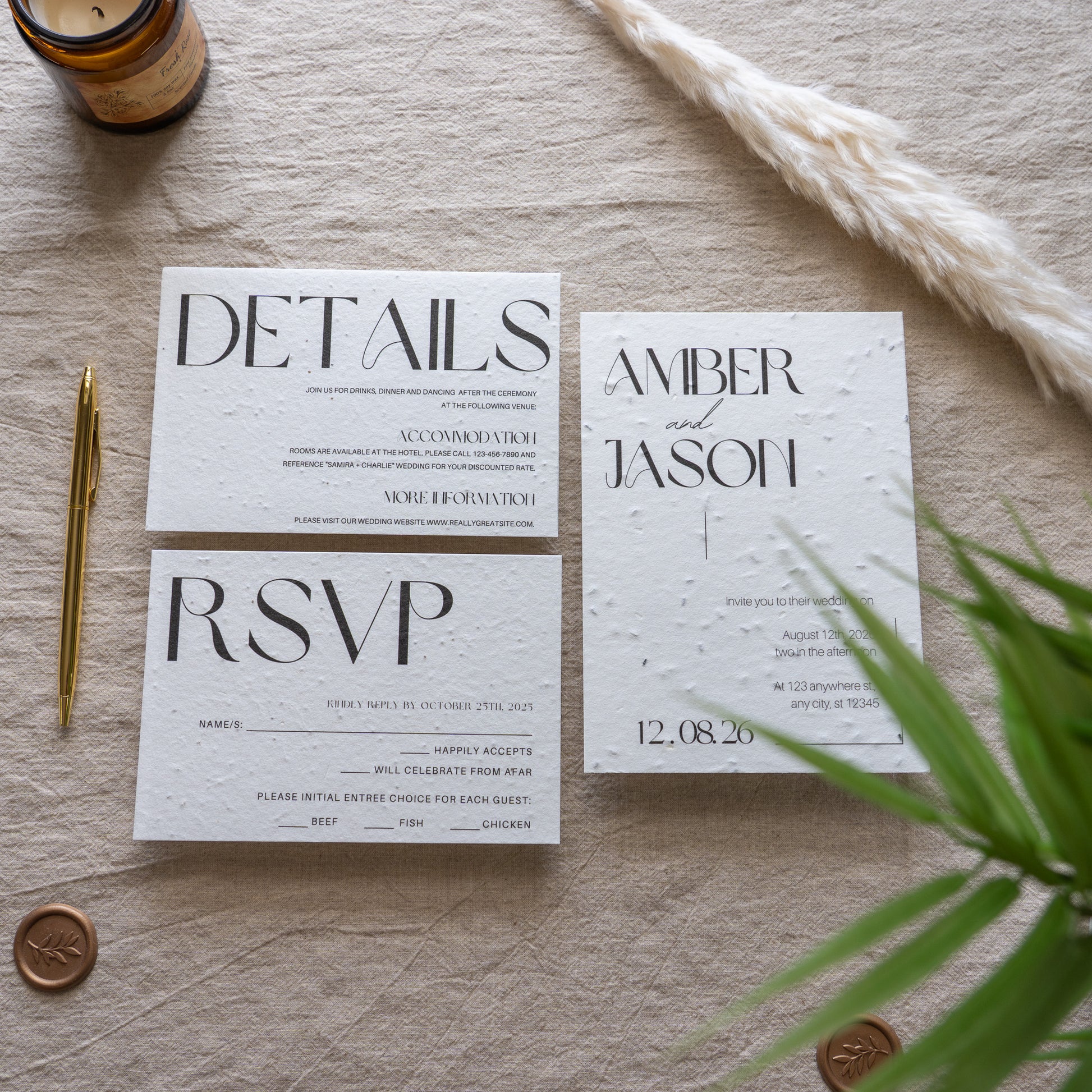 Set of wedding invitations with RSVP card on a textured surface with decorative elements.