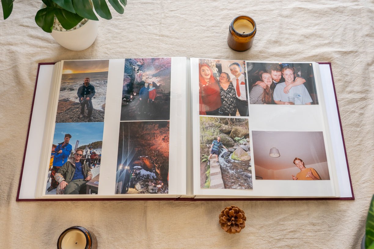 Open photo album on a wooden surface with family photos inside