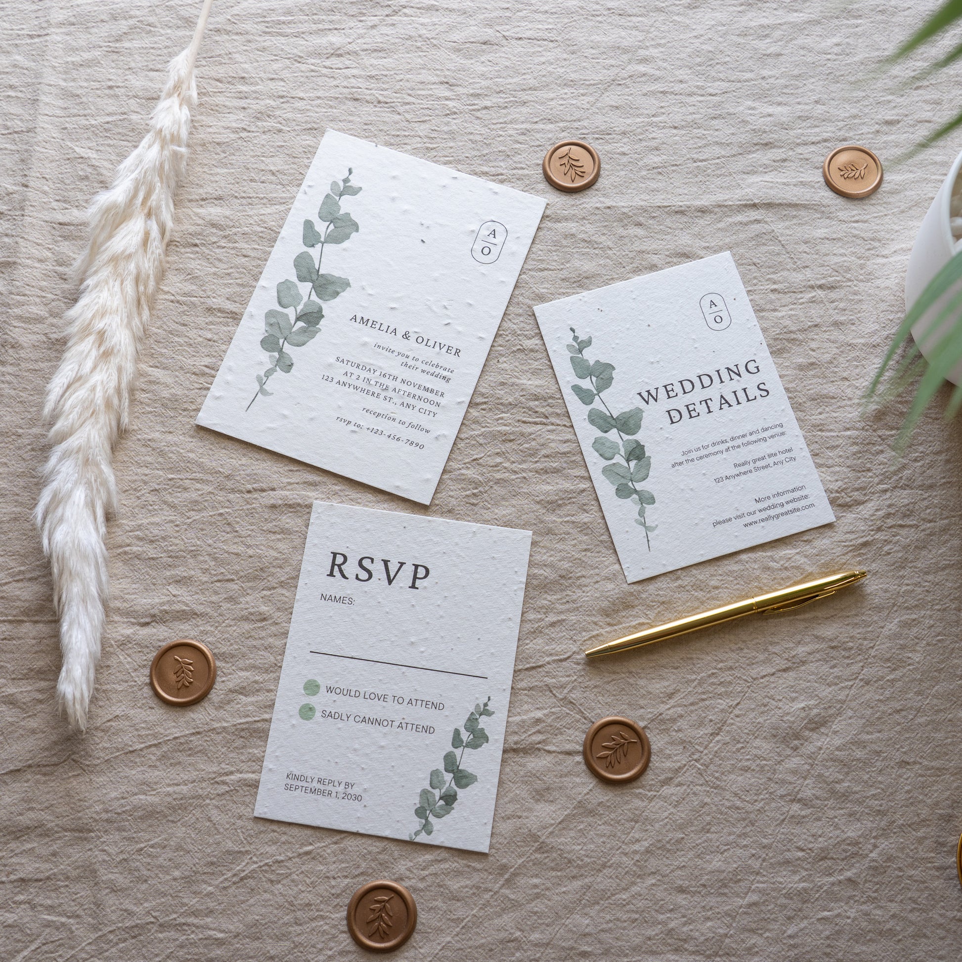 Wedding invitation set with RSVP card on a textured surface with decorative elements.