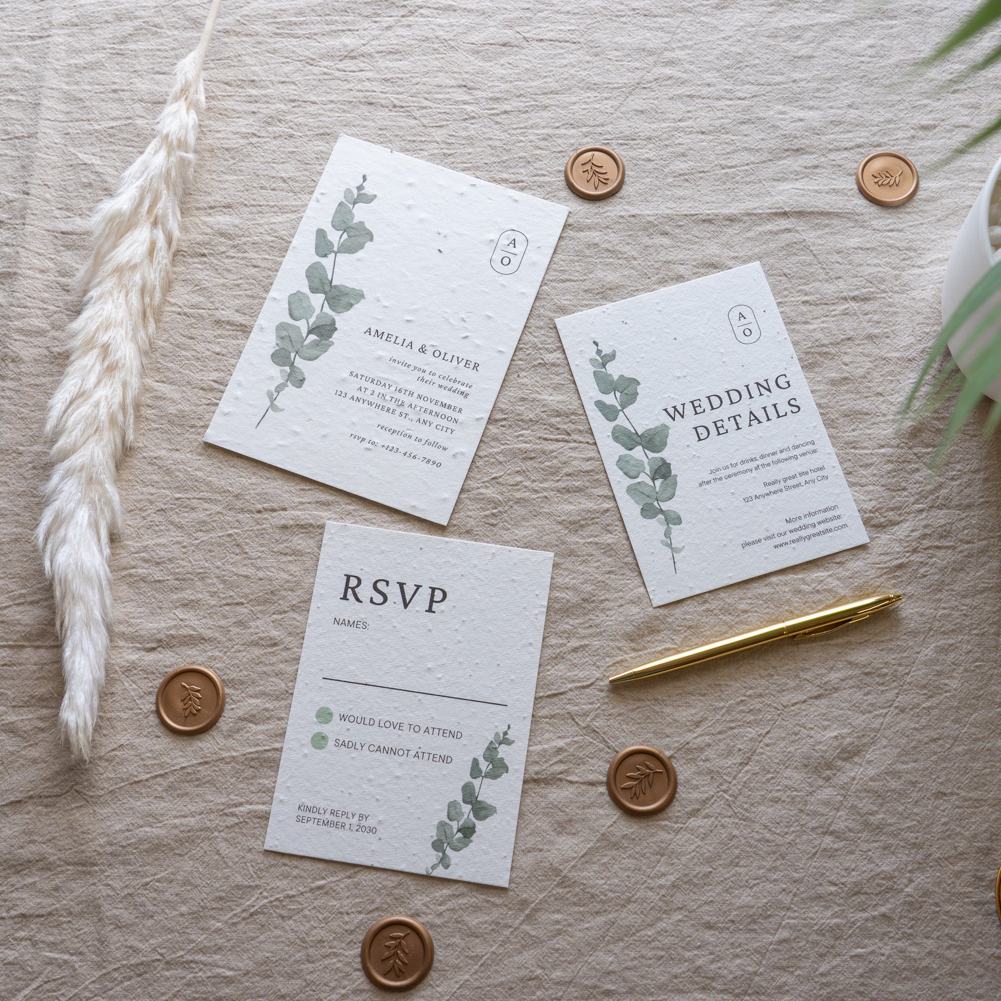 Wedding invitation set with RSVP card on a textured surface with decorative elements.